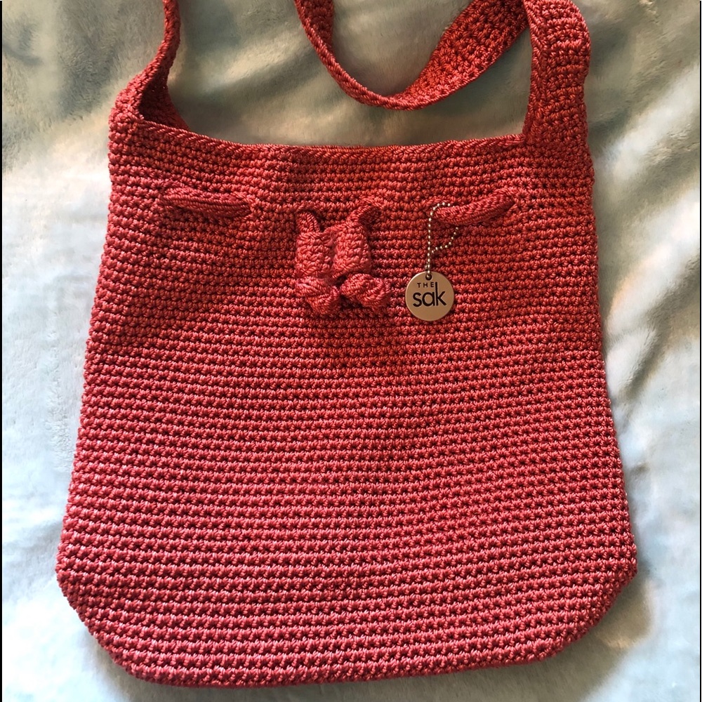 Pink coral mini crochet The Sak purse.